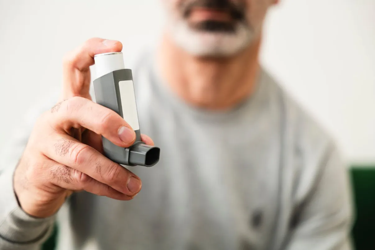 Man using an asthma inhaler