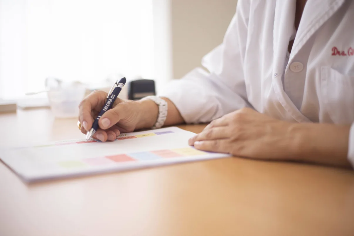 Doctor completing credentialing paperwork at a desk