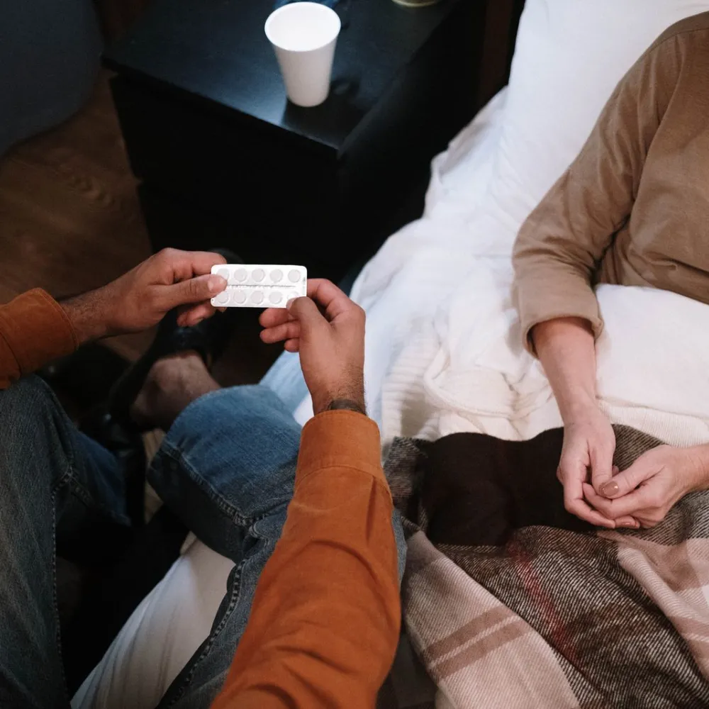 Caregiver talking with an older patient about medication at home