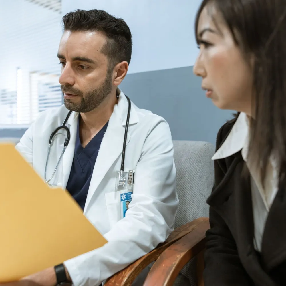 Doctor reviewing health records with a patient