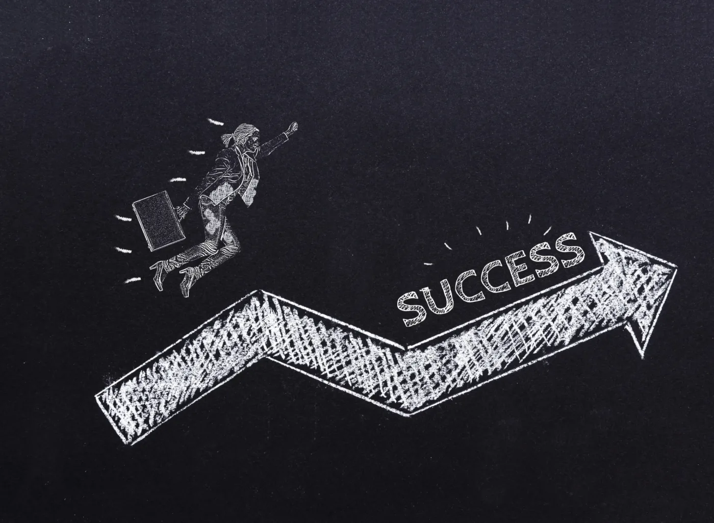 Chalk arrow labeled success rising on a blackboard