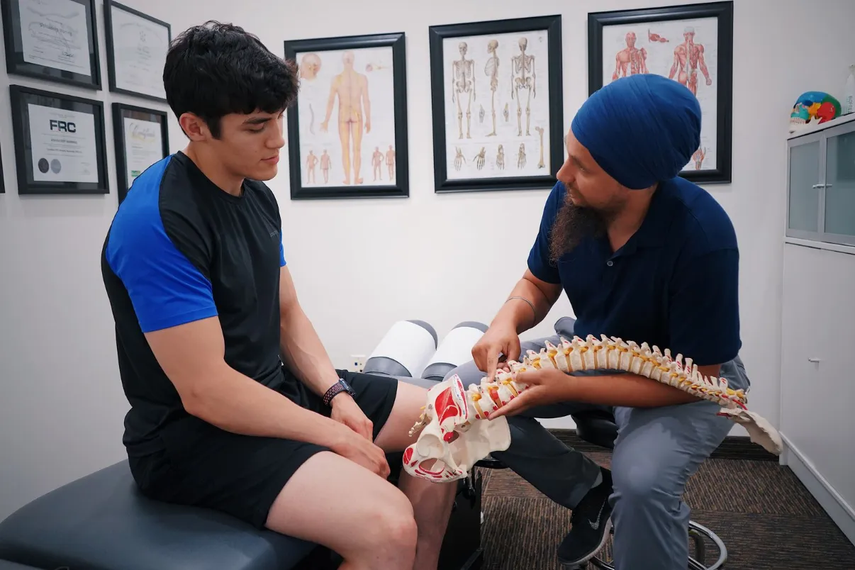 Doctor explaining spine problems to a patient with a spine model