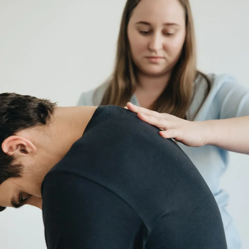 Clinician treating a patient with back pain