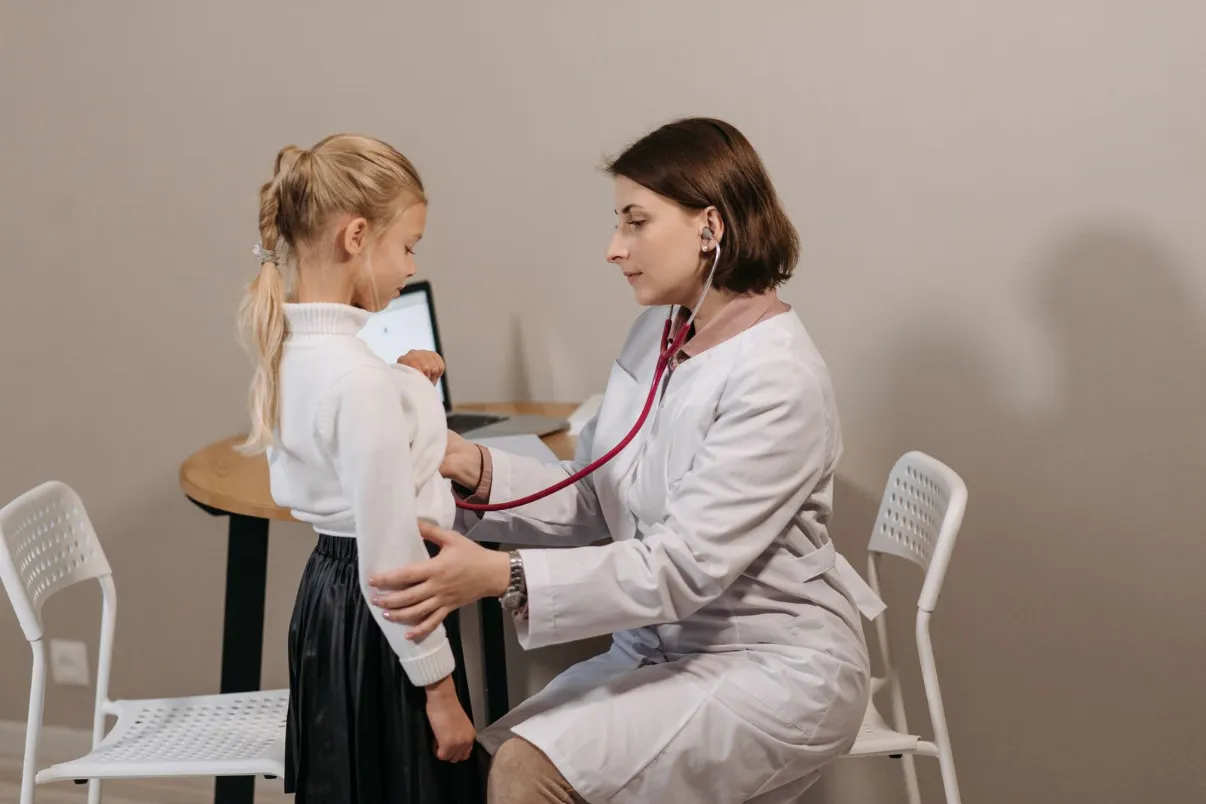 Pediatrician listening to a child's heartbeat during a checkup