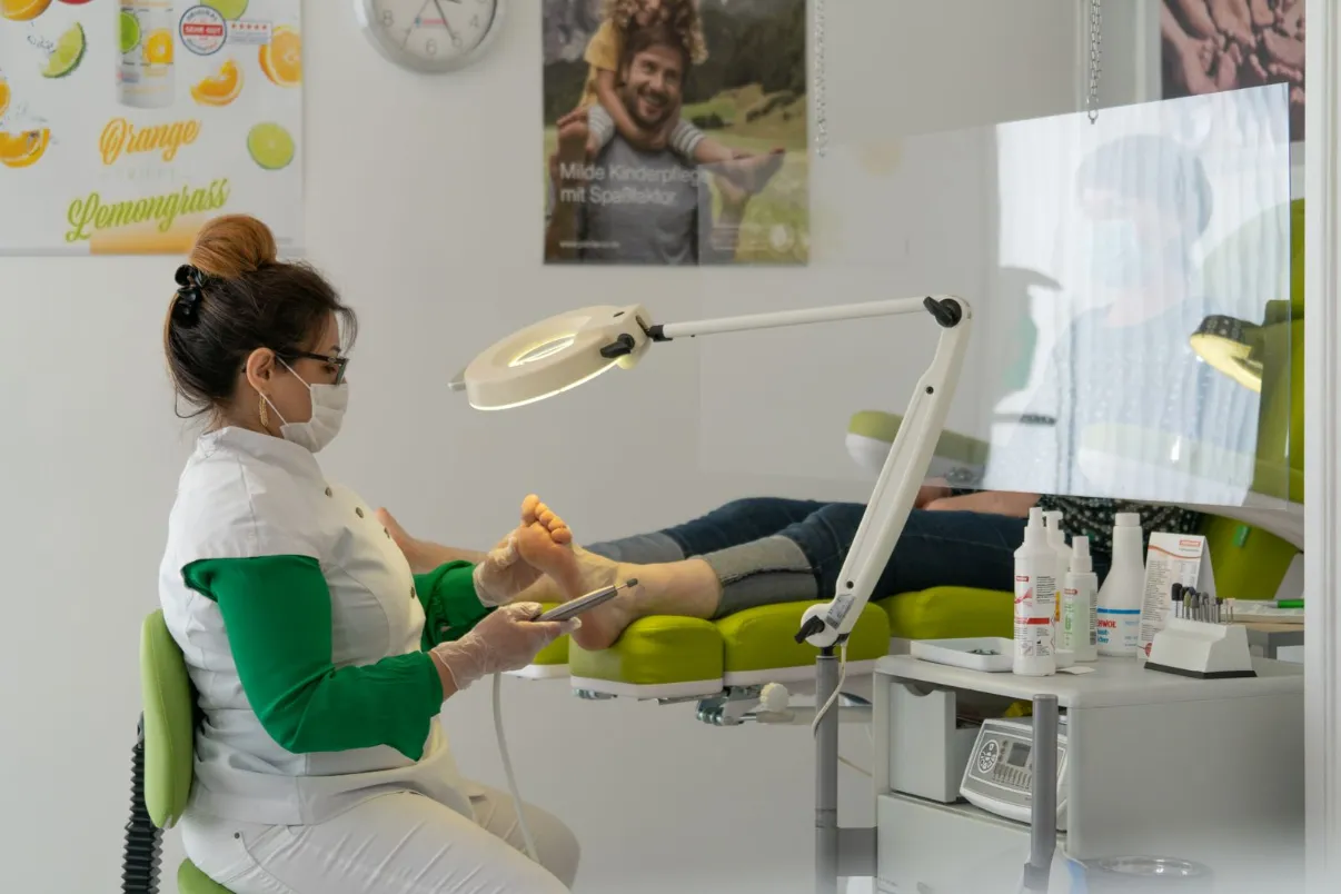 Podiatrist treating a patient's foot in a clinic