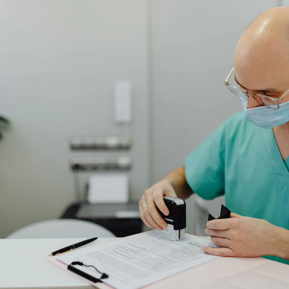 Provider signing documents in a medical office