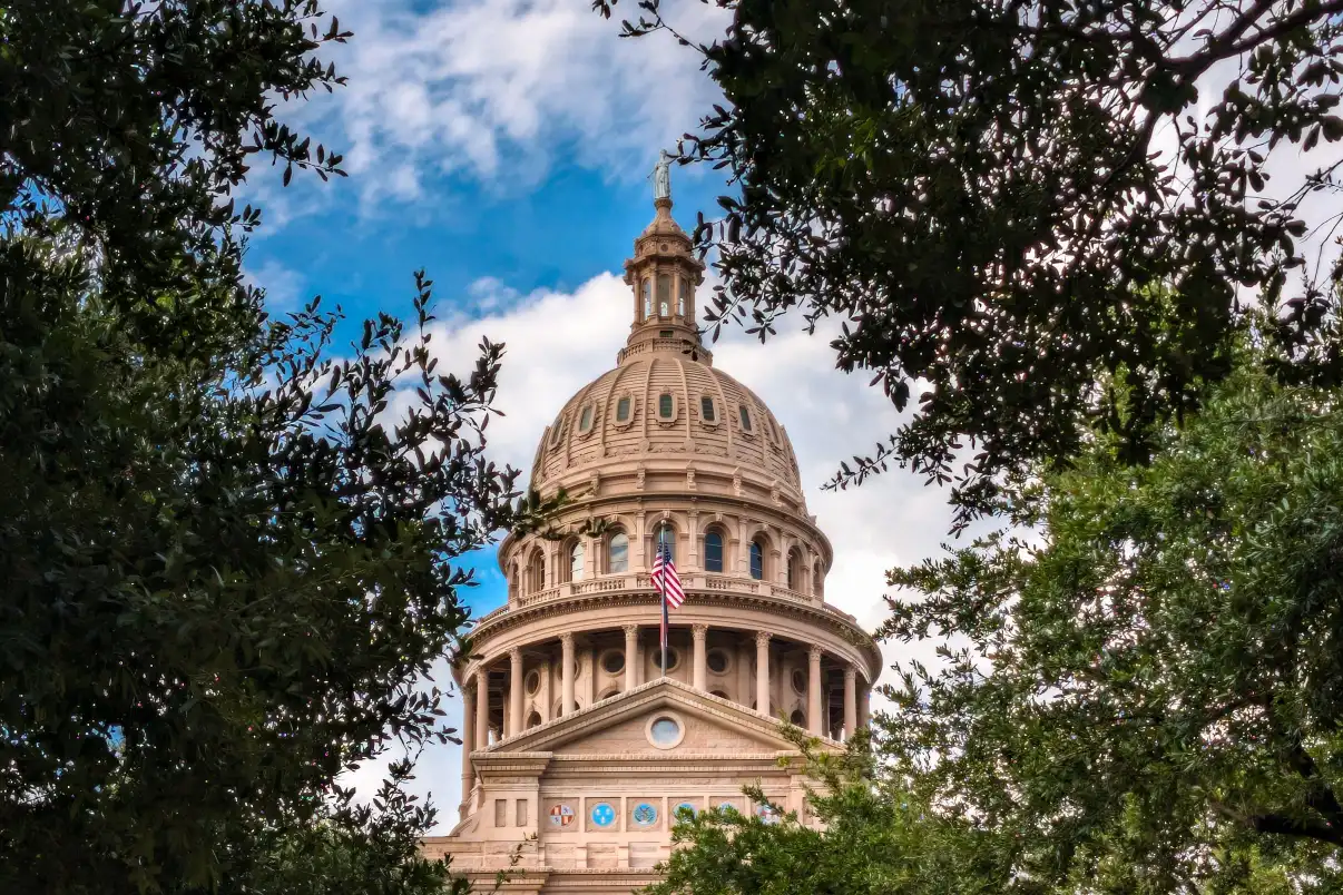 Texas State Capitol in Austin framed by trees