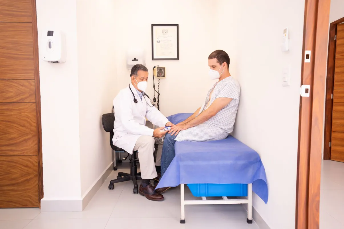 Doctor checking a patient's vital signs in an exam room